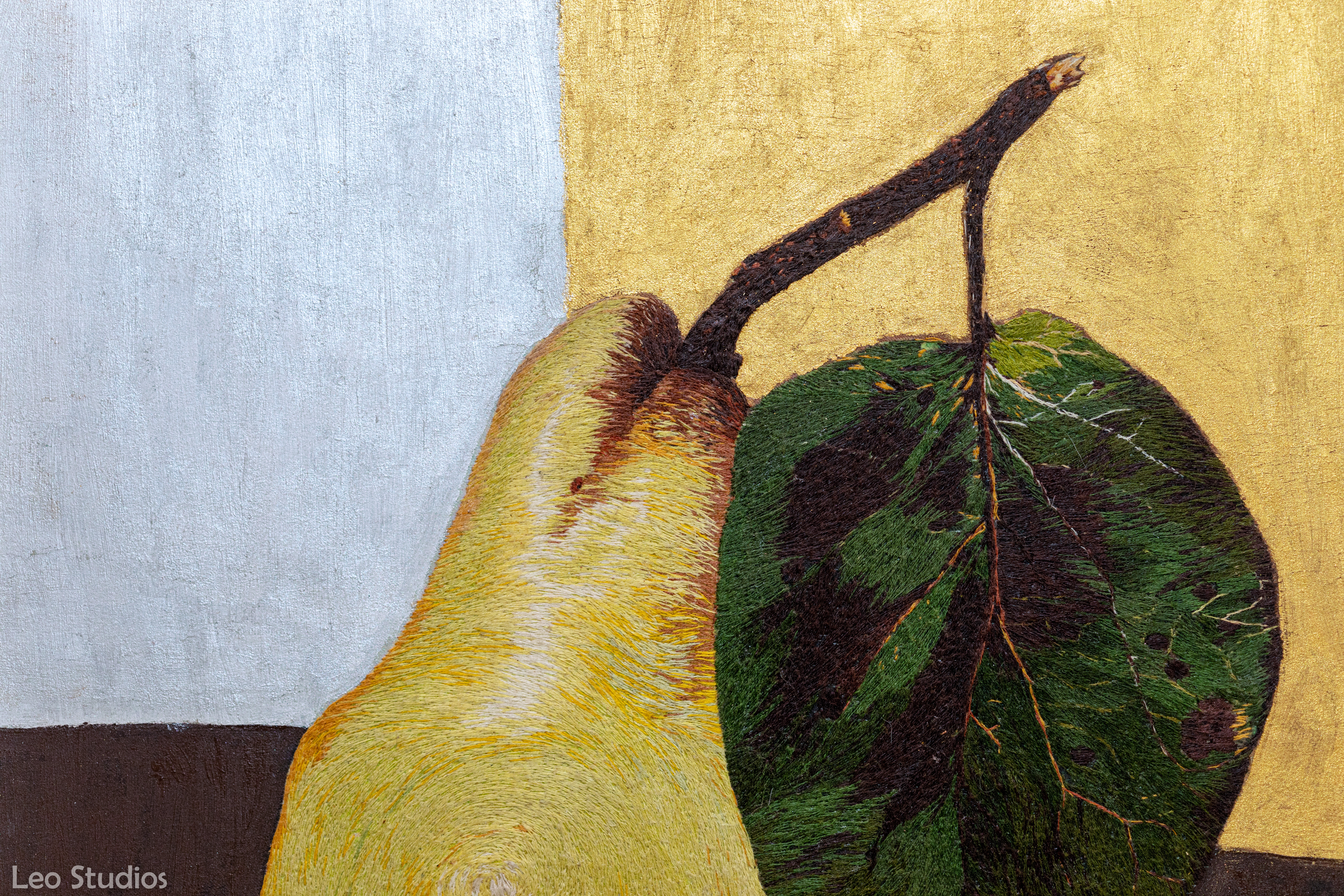 Portraying still life in the form of a fruit past its prime. Decay in the leaves and the changing colours of a ripening fruit have been portrayed true to form. Incorporation of a whorl in the body of the pear was an added twist
A coming together of pure earth tones depicted in the yellow browns of an over ripened fruit and the muddy greens of a decaying leaf.